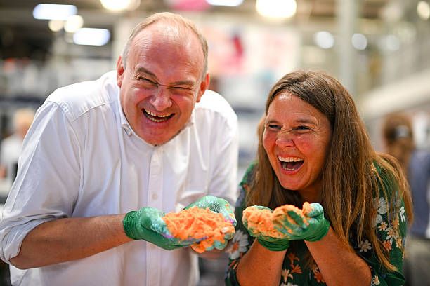Ed Davey, Leader of the Liberal Democrats and Vikki Slade, Liberal Democrat MP for Mid Dorset and North Poole smell the ingredients as they learn to make bath bombs during a visit to the Lush factory, on July 18, 2025 in Poole, United Kingdom