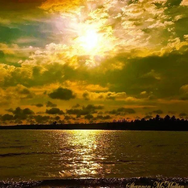 Evening boat ride with golden reflections on bronzed waves at sunset. 
