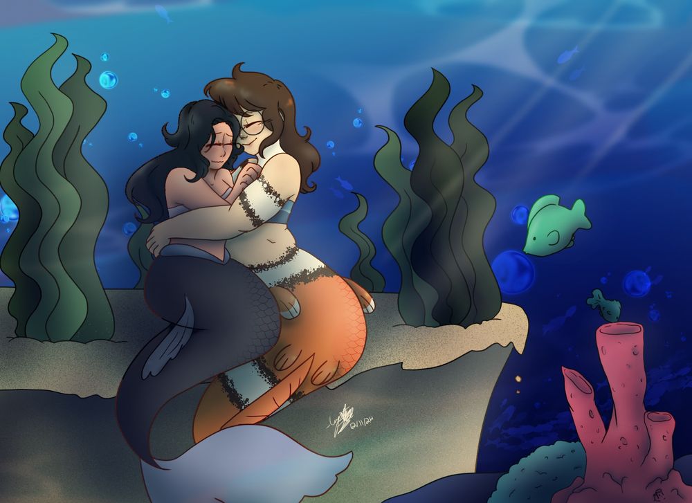 Two mermaids hugging under the sea. Vicky, with black hair and tail, and Maya, a clownfish tailed brunette 