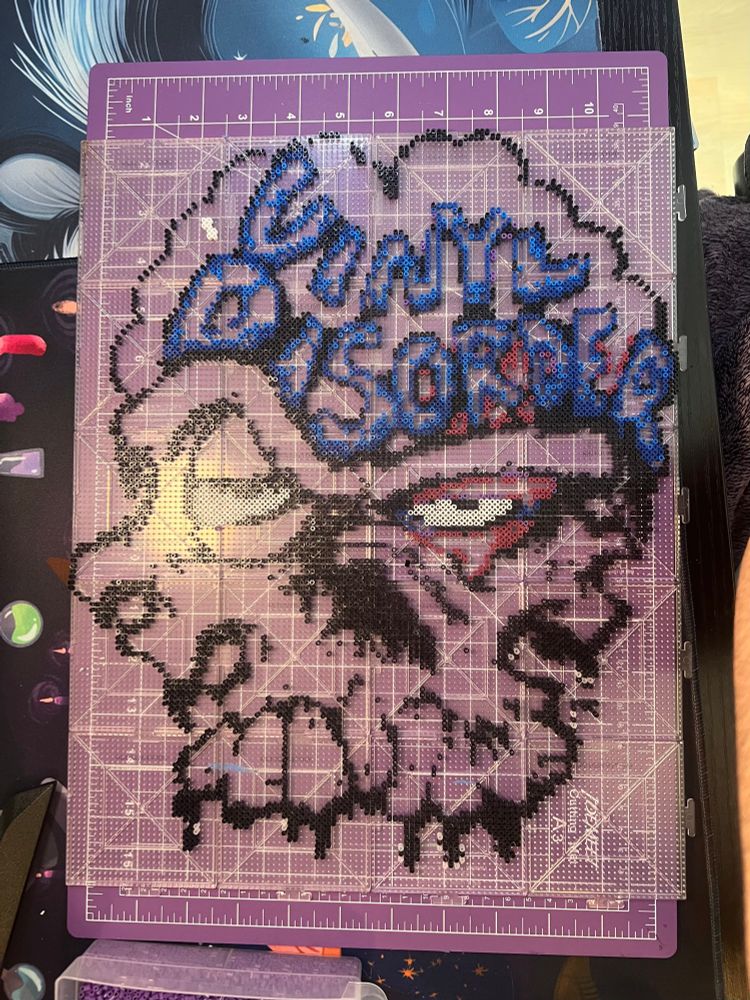 Vinyl disorders logo made from small fuse beads.