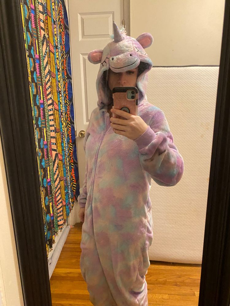a woman in a unicorn onesie 