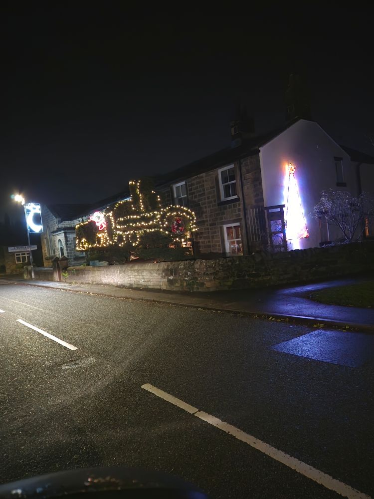 Sooty's workshop with Christmas lights - santa riding a steam train. 

Main Street, Menston. 

