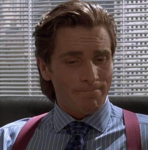 A picture of Patrick Bateman from American Psycho. He's grimacing.
