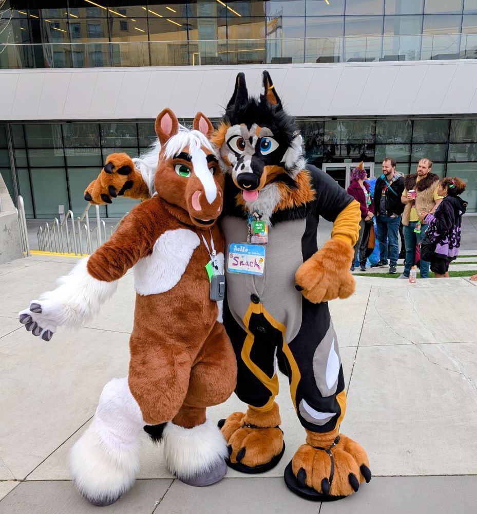 A dog and horse fursuit positing for a picture