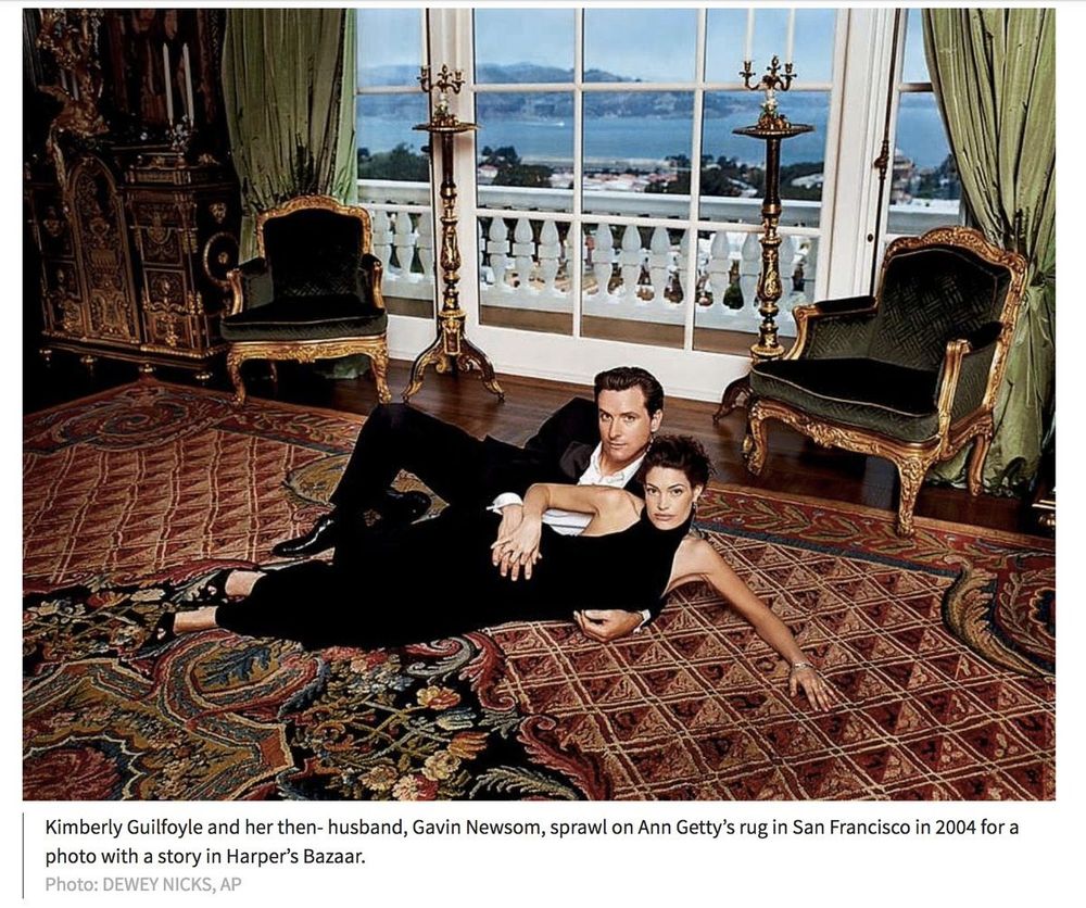 Gavin Newsom sprawled on a rich carpet in the Getty Mansion in 2004 with then wife Kimberly Guilfoyle