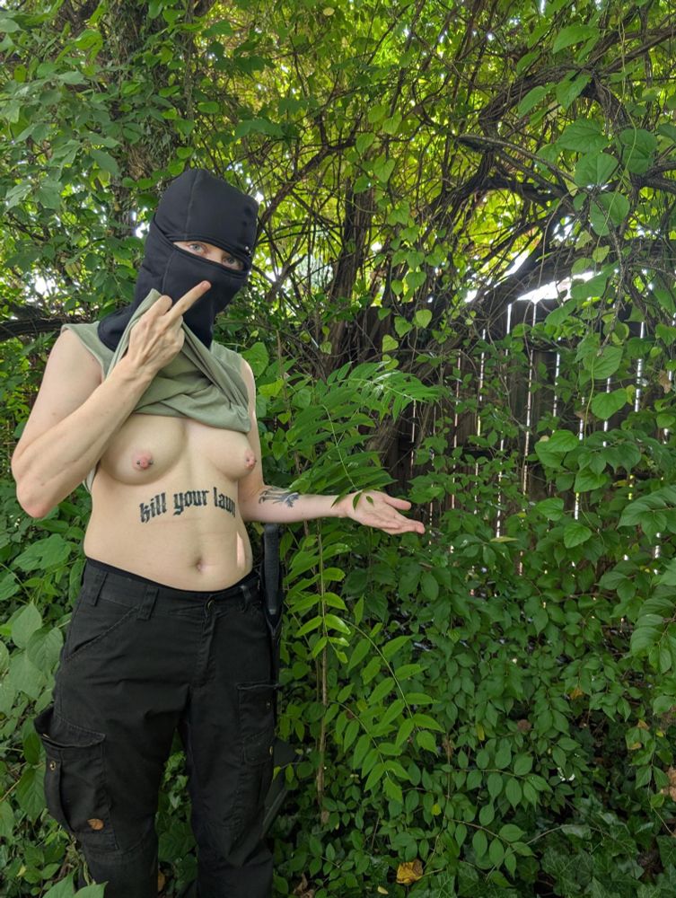 nude of weird guy next to invasive plant