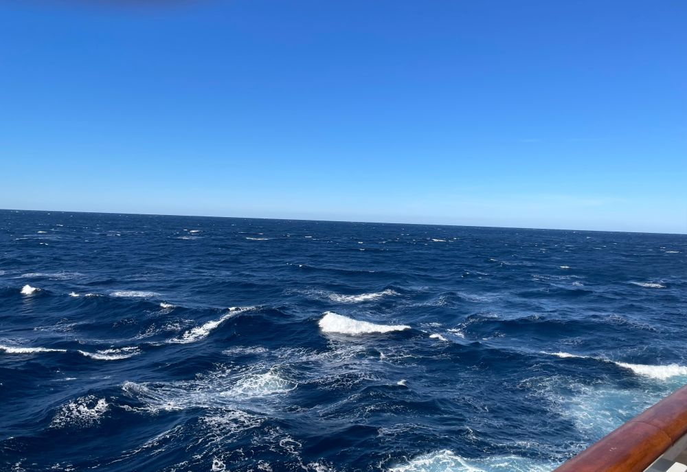 a clear blue sky and a deep blue ocean.