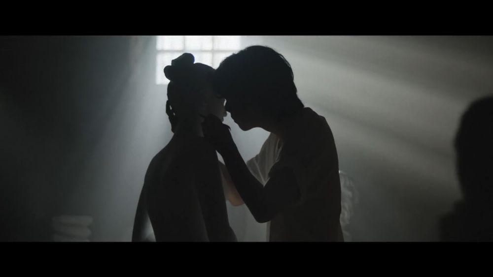 V caressing a sculpture in the Winter Ahead teaser video on YouTube.