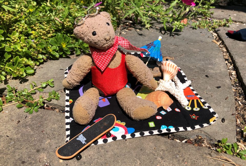 Chuckie suns himself on a blanket in swimwear