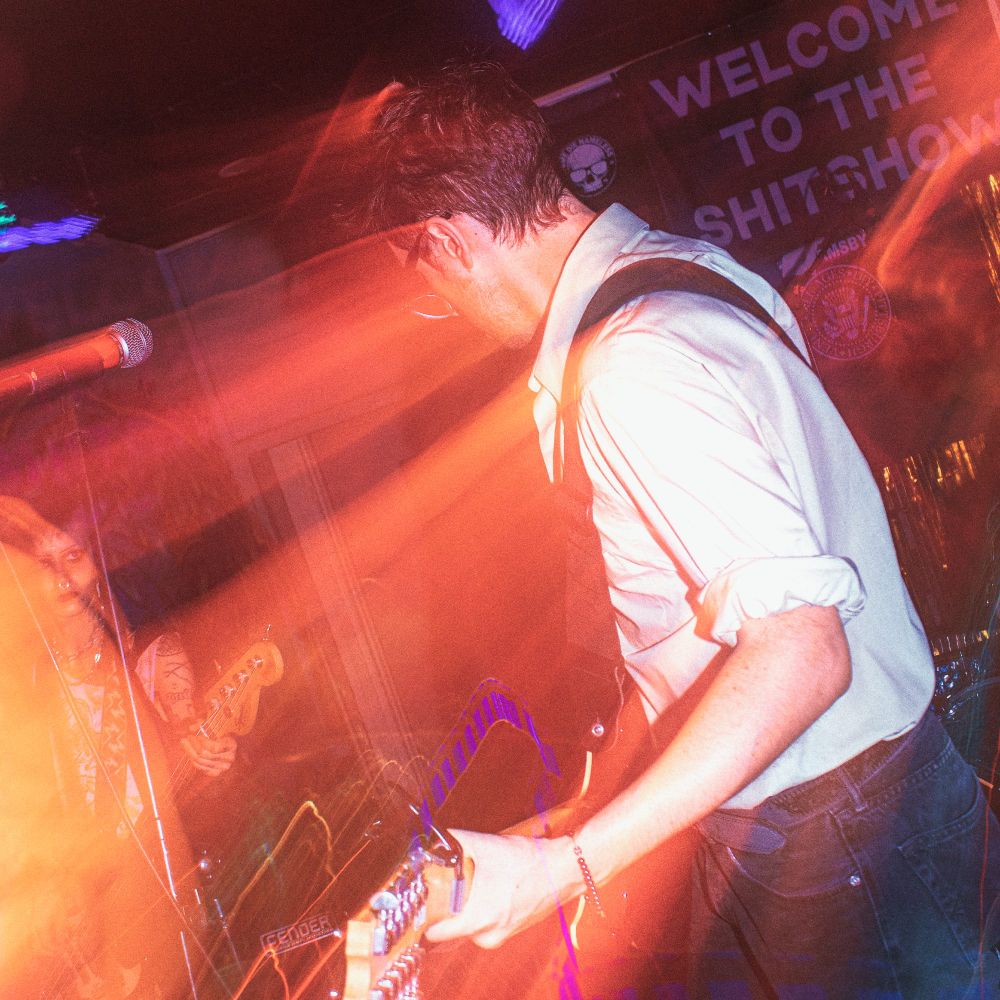 Nowhere Wolves performing - J. Trafford playing electric 12-string guitar.