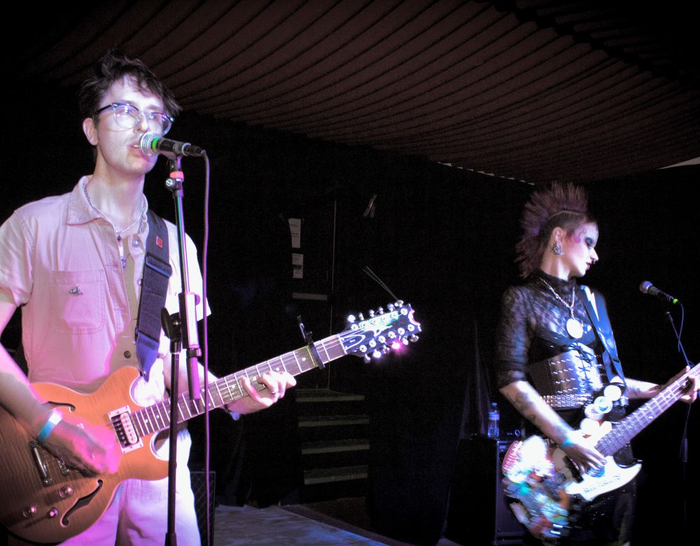 Nowhere Wolves performing: J. Trafford singing and playing 12-string electric guitar, Candrika Rice playing electric bass.