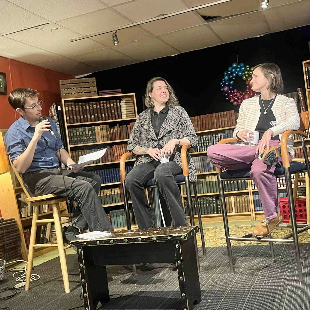 Photo of J. Trafford, Lauren DeMichiei, and Hannah Bingman speaking onstage.