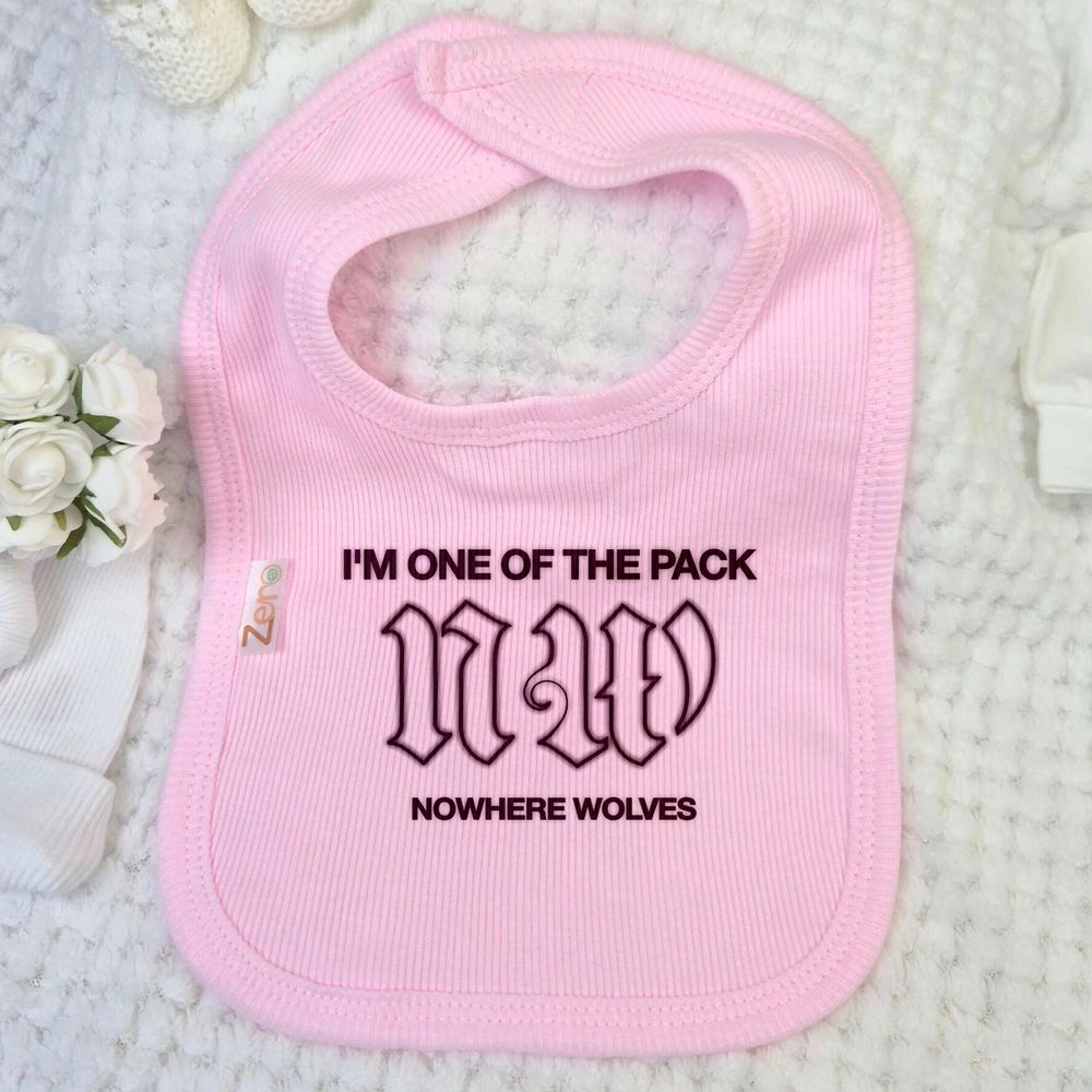 Pink baby bib with black text reading "I'm one of the pack
NW
Nowhere Wolves"