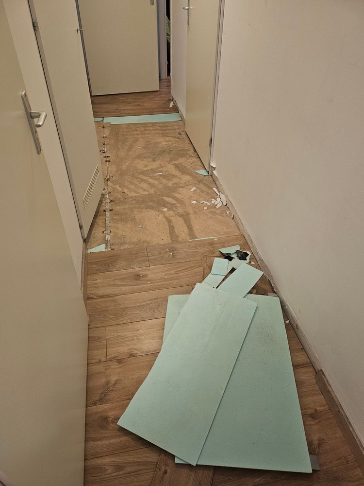 Wider picture showing the floor partially removed, with damp concrete visible.