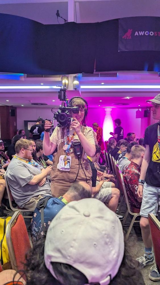 Picture of me from the crowd filming with the camera and setup on my shoulder. The camera is pointed at the viewer 