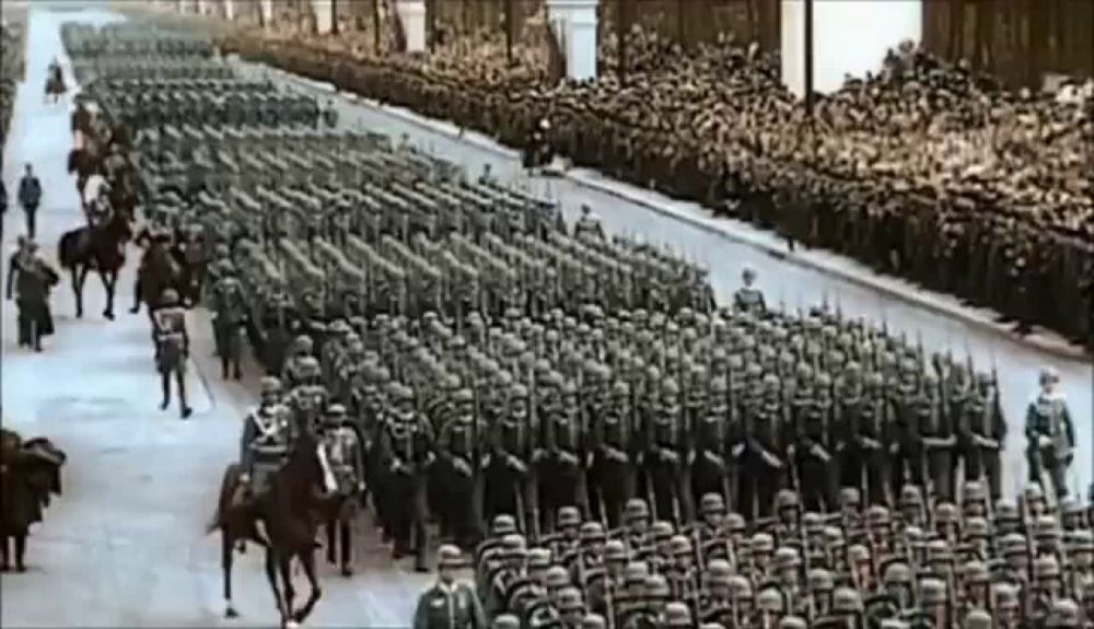 a black and white photo of a military parade with soldiers on horseback