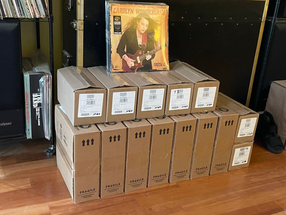 A stack of boxes containing CDs and Vinyl records labelled Truth Is.