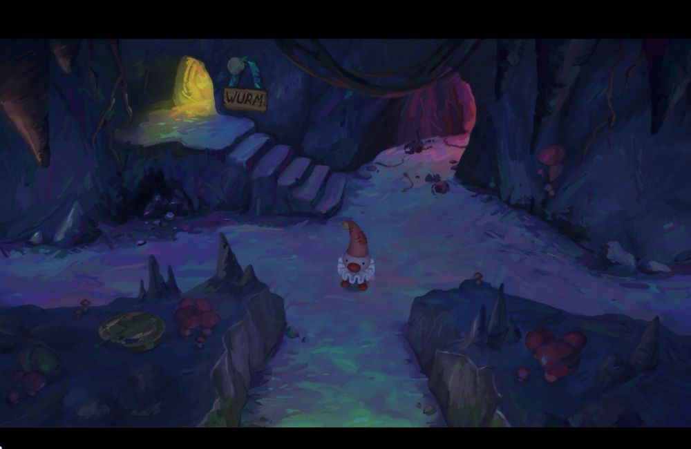 A screenshot from Poco. Poco the clown stands in a dark cavern with multiple path options branching out from
The center. Some of the paths lead to hallways with ominous but colorful glows emanating from them