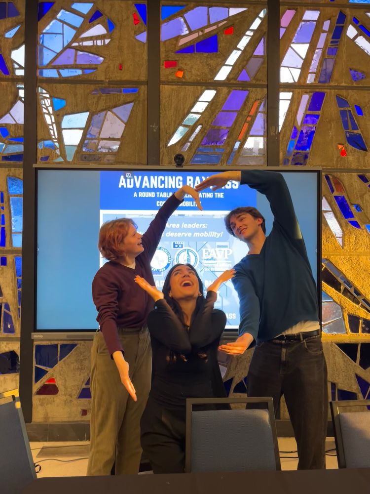 Ren and 2 other students posing in front of a sign for the panel “Advancing BayPass”, 

circa spring 2024