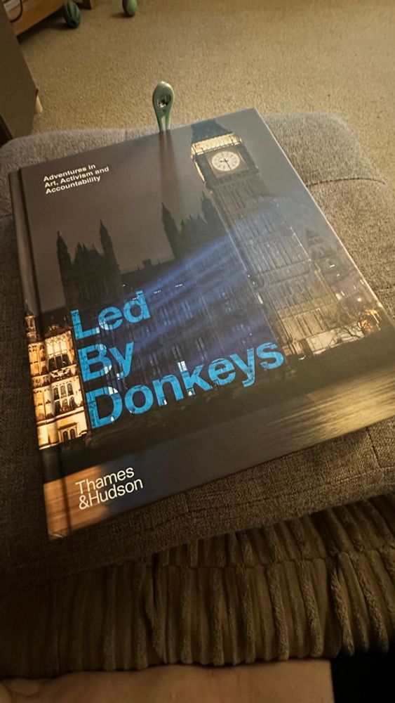 Led by Donkeys hardback book on a cushioned foot stool 