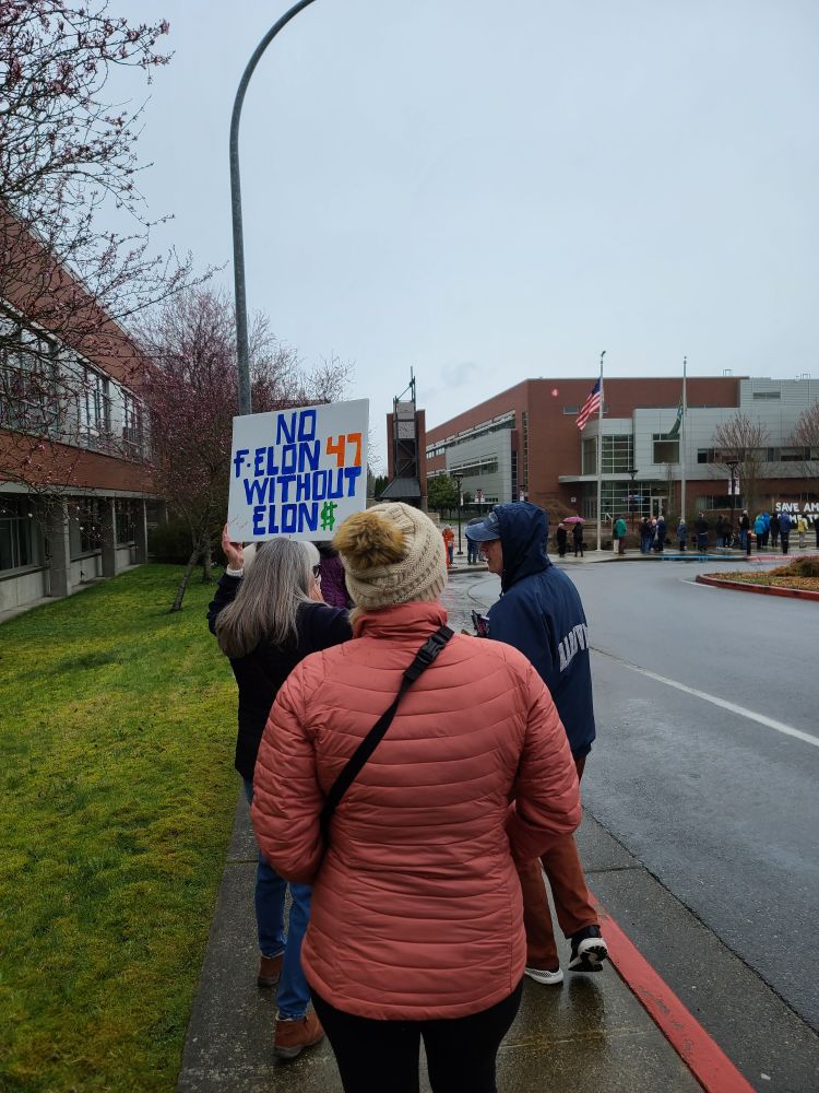 Protest sign reads: no f-elon 47 without Elon $$