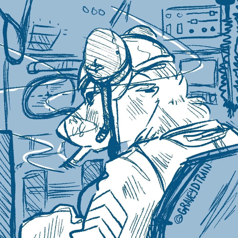 Gravey looking over his shoulder at the camera with a cigarette in his mouth. He is in the "gunner's hole" of the tank he served in.