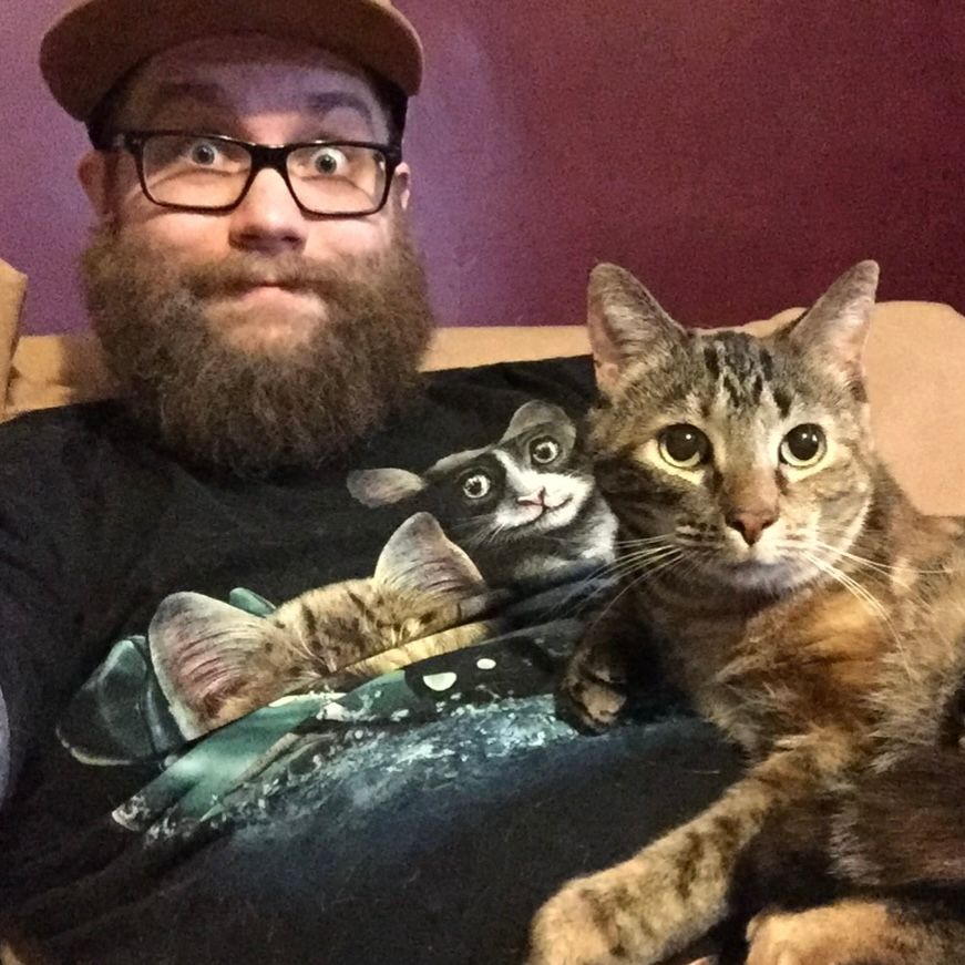 A guy holding his cat nine years ago