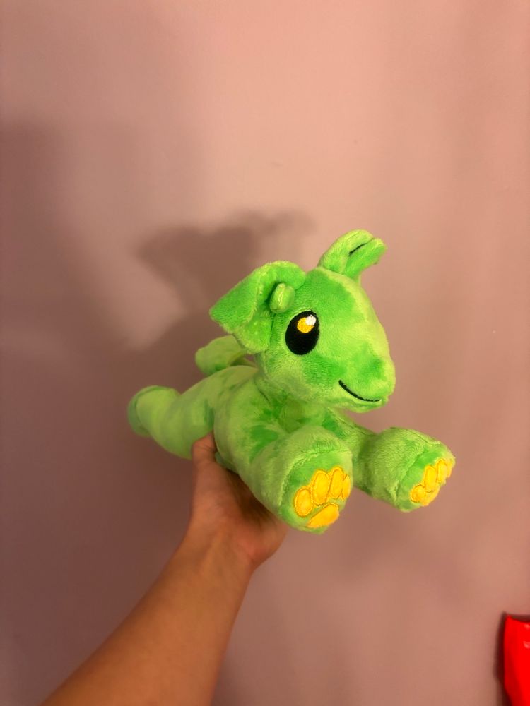 Green puppy with alien antenna and yellow beans