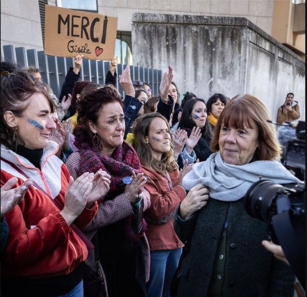 Gisele Pelicot walks past hundreds of cheering women, some holding signs saying "Merci Gisele", outside the court where her husband and 50 other strangers were tried for raping her while she was drugged.