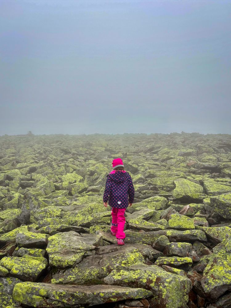 A little hiker walks through a stone sea into the void.