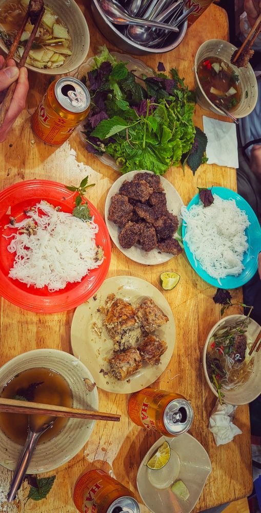 A vibrant table adorned with numerous plates of appetizing food, creating a feast for the eyes and taste buds.