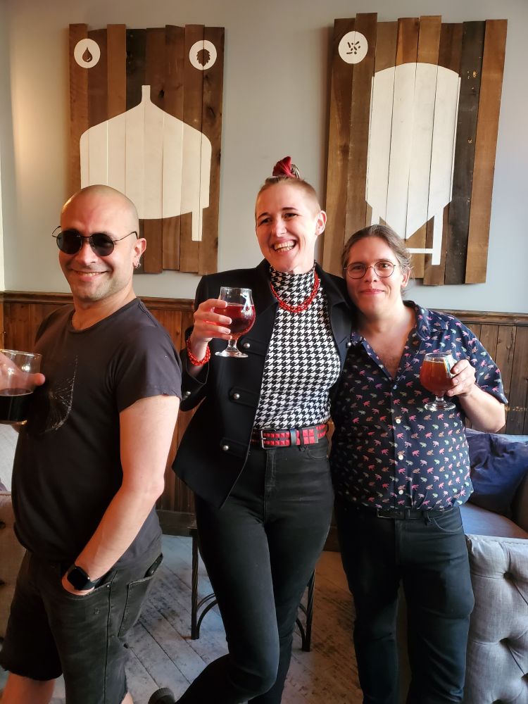 Don, Ryvre, and Daniel holding drinks at Beermiscuous 