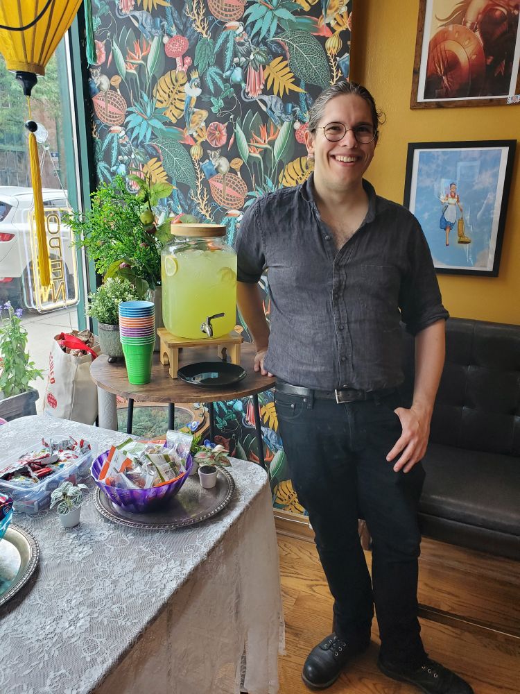 Daniel with a jug of lemonade and bowls of snacks