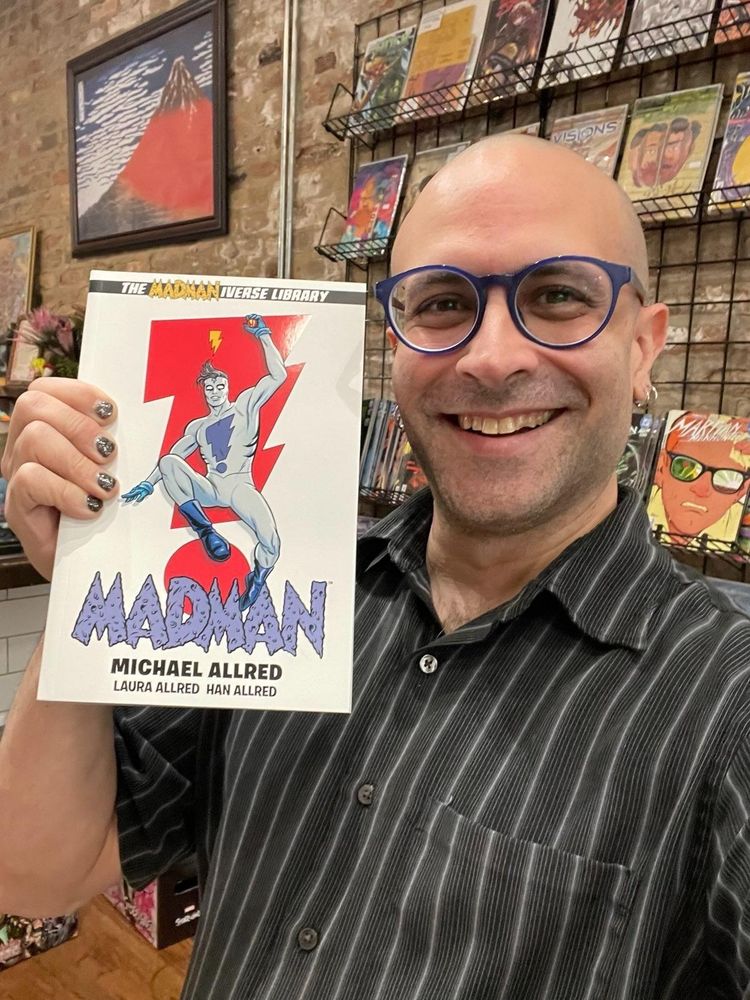 Don Alsafi of Goblin Market holding the Madman Omnibus by Mike and Laura Allred 