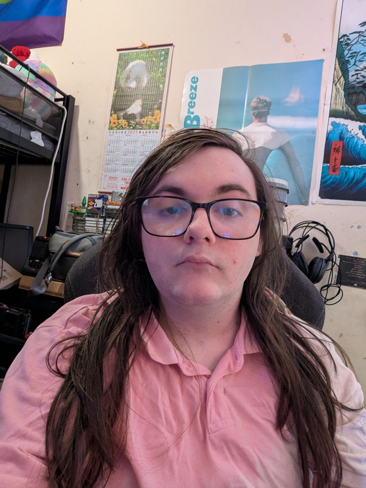 Me without hair tied back 
Wearing pink shirt 
