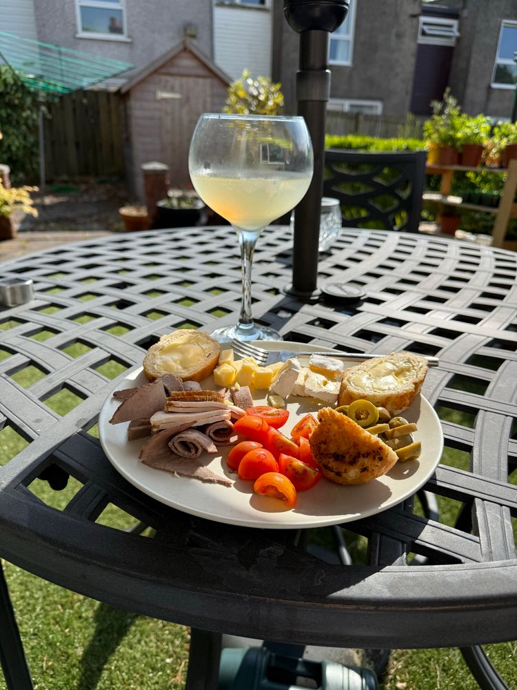 Plate with nibbles on a sunny evening and a cocktail 