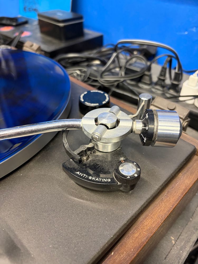 a close up of a record player with ANTI-SKATING written on the base of the arm