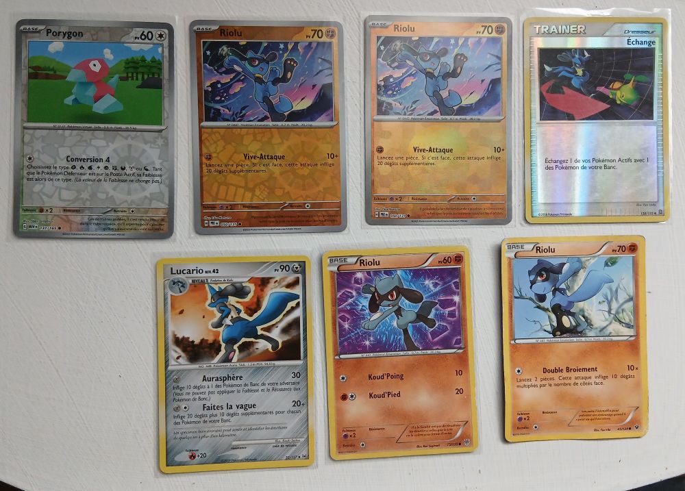 Some Pokemon cards featuring Riolu, Lucario and Porygon.