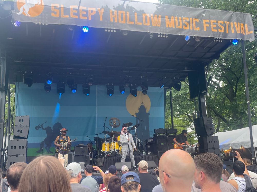 Wide shot of the band Living Colour playing on the main stage of the Sleepy Hollow Music Festival.