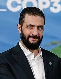 Picture of Ahmed al-Sharaa, also smiling(?)