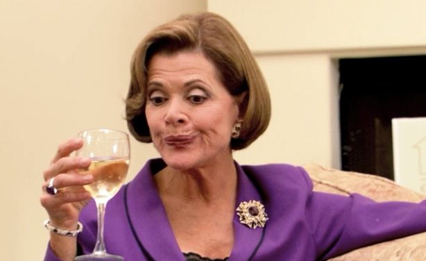 Lucille Bluth pursing her lips and putting down a glass of wine,  cuz shes unimpressed