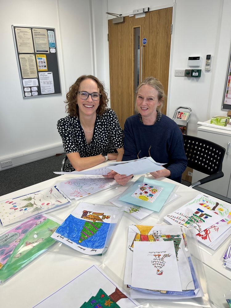 Alison and Kate looking through Christmas card competition entries