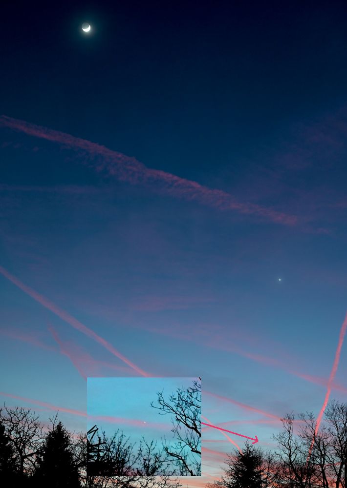 Photo of the waxing crescent moon with Venus and Mercury at dusk.