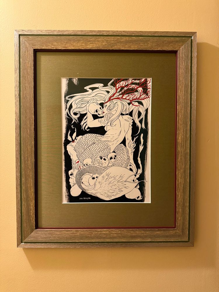 “Mermaid’s Kiss” art by Jen. Black and White mermaid with skull. Red accents. 