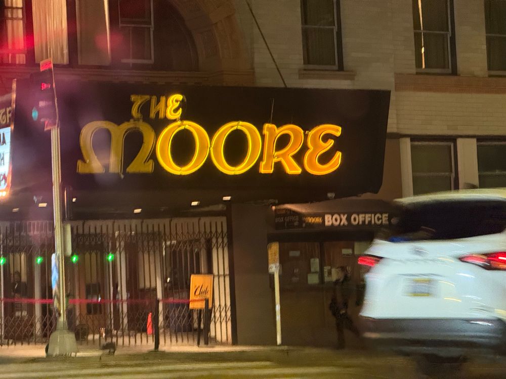 “The Moore” theater sign with lights out so it reads “e Oore.”