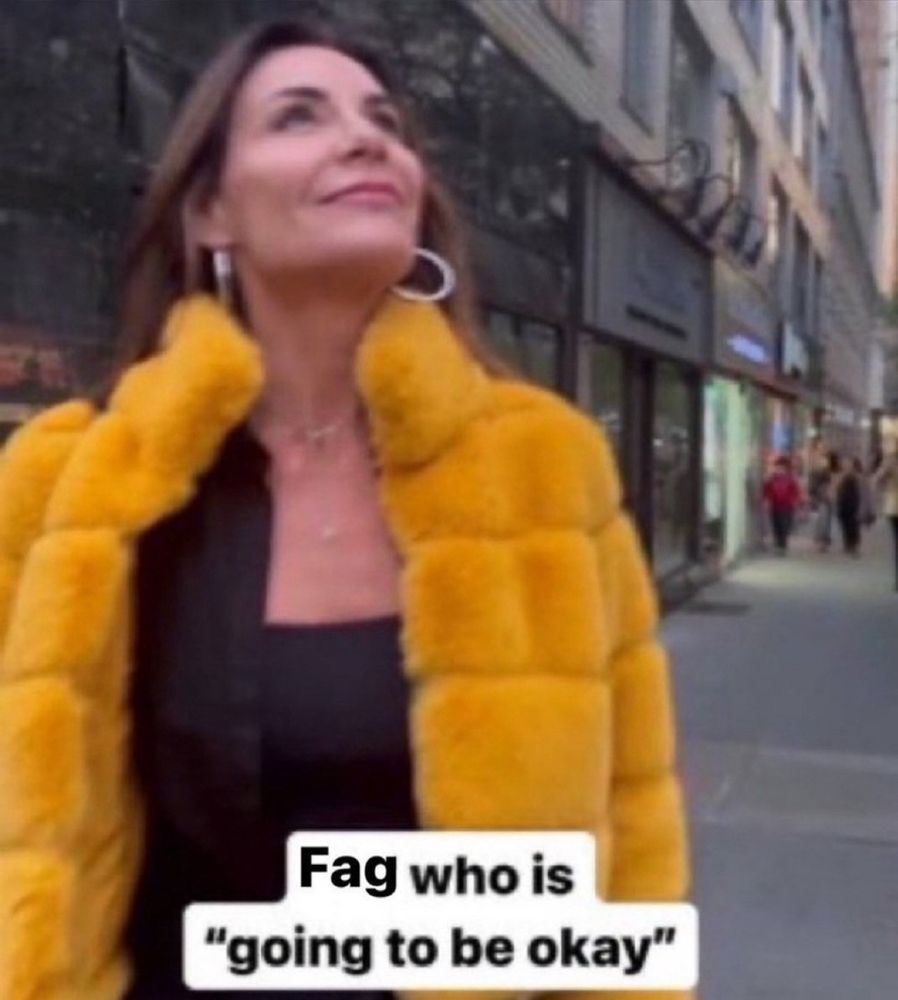 woman in a hideous yellow fur coat is looking up, with determination and happiness, the caption says "Fag who is 'going to be okay'" 