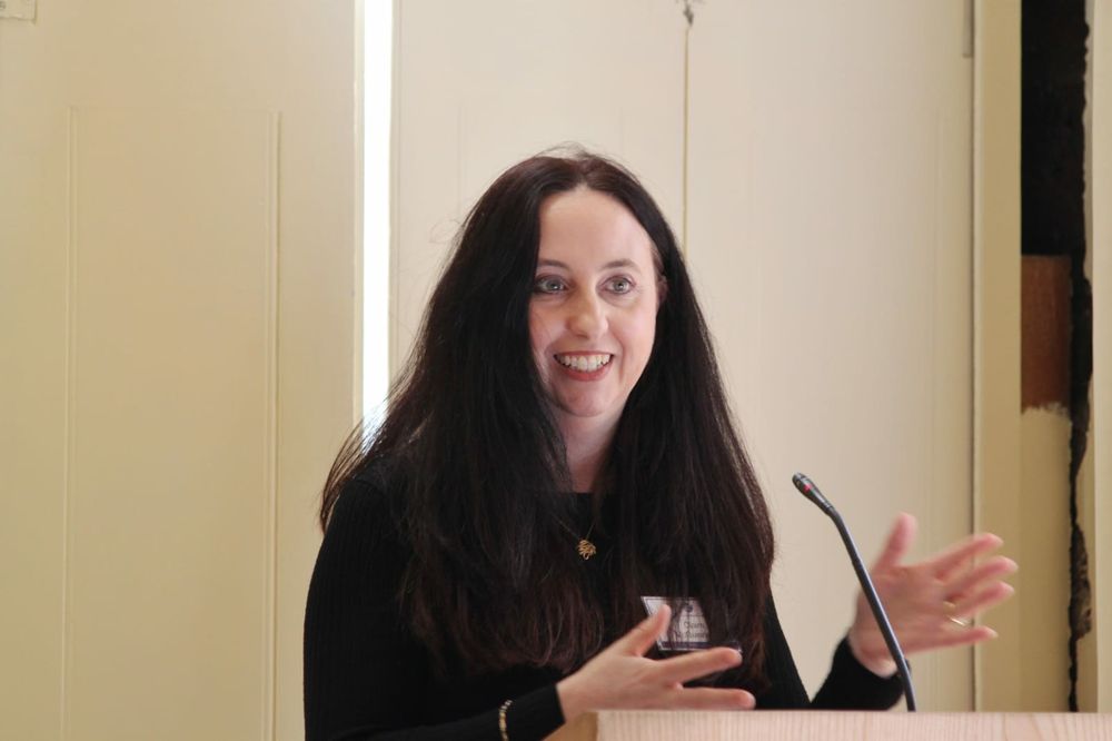 A woman speaks from a lectern