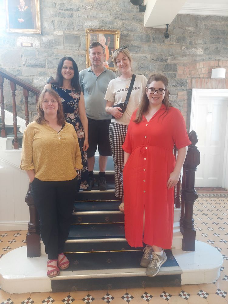 Five people standing on stairs