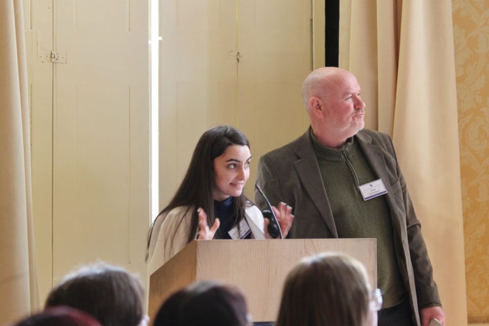 A woman speaks from a lectern 