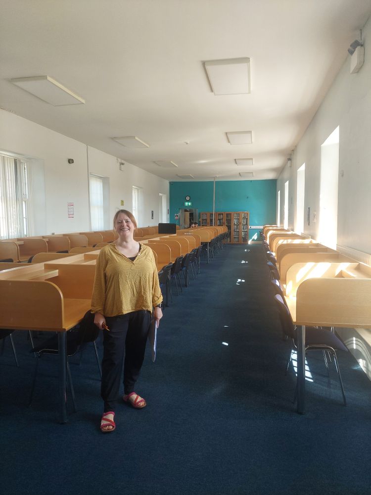 A woman standing in a room with study booths
